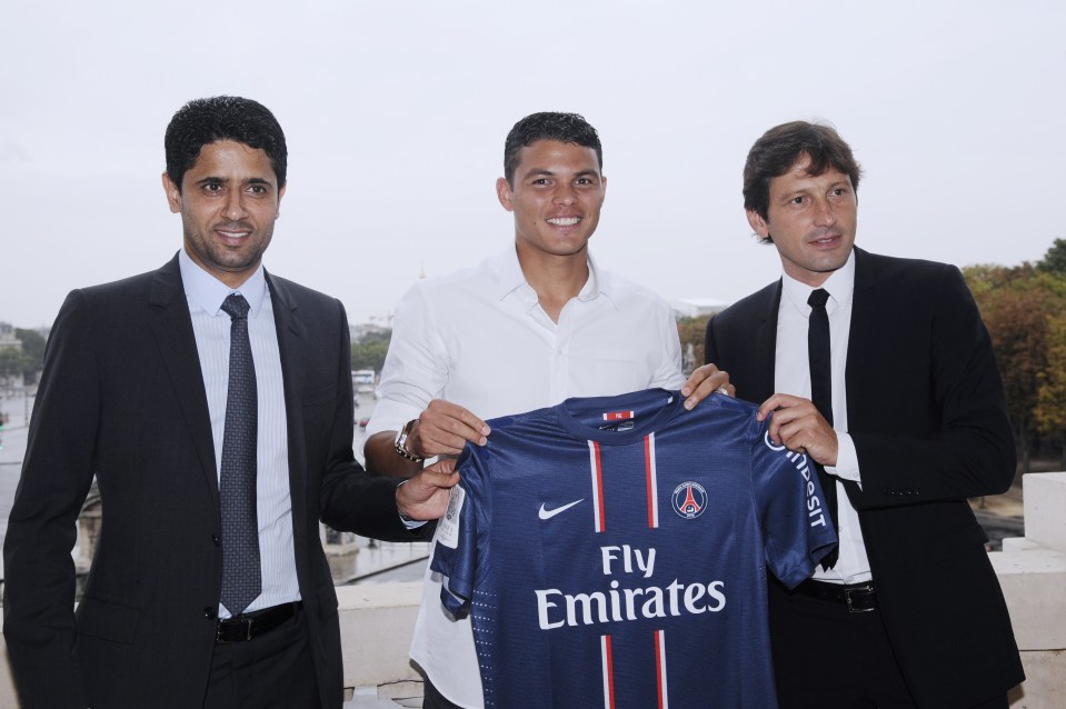 Paris Saint-Germain (PSG) newly recruited Brazilian defender Thiago Silva (C), PSG's football club's chairman Nasser Al-Khelaifi (L), and PSG's Brazilian sporting director Leonardo (R), pose with his new jersey after a press conference on August 24, 2012 at the Hotel Crillon, in Paris. AFP PHOTO / BERTRAND GUAY (Photo credit should read BERTRAND GUAY/AFP/GettyImages)
