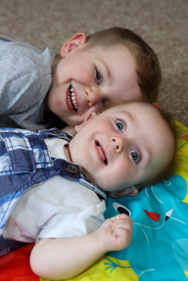 Brian, with big brother Arthur, lives with visual impairment, bilateral hearing loss and cerebral palsy