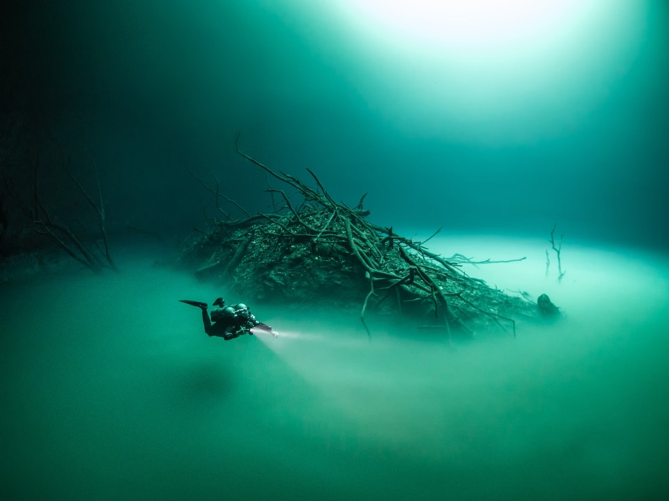 A mound of debris pokes through the cloud, giving the impression of an island