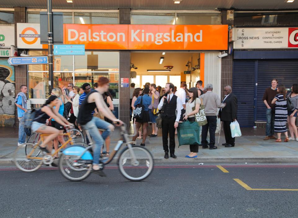 a group of people are waiting outside of dalston kingsland