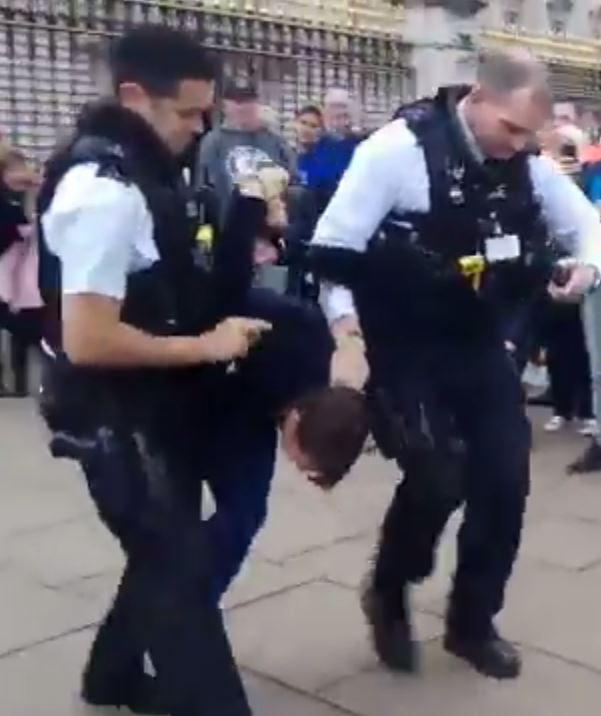 The woman is cuffed and dragged away 