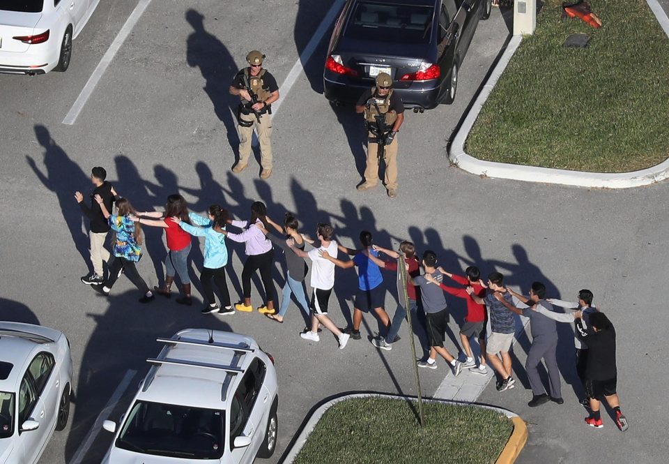 Terrified students are brought out of the Marjory Stoneman Douglas High School after a shooting