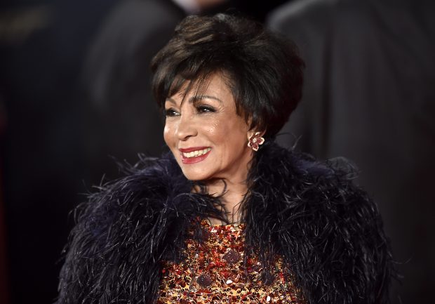 Dame Shirley Bassey in a glittering dress and a fur coat