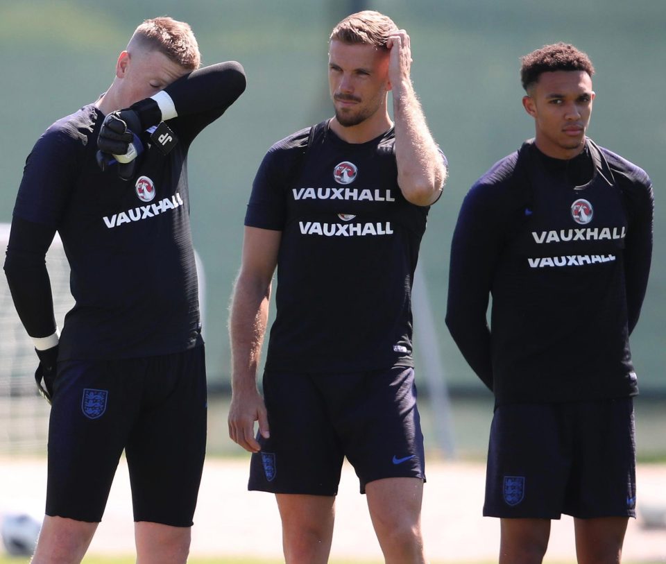 Jordan Pickford, Jordan Henderson and Trent Alexander-Arnold dry themselves down in preparation for the minute's silence