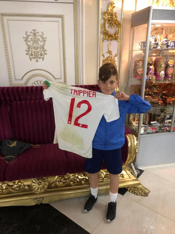  11-year-old Alfie Wall grins as he holds aloft Kieran Trippier's World Cup semi-final shirt - he'd asked the star for it before the match and he was true to his word