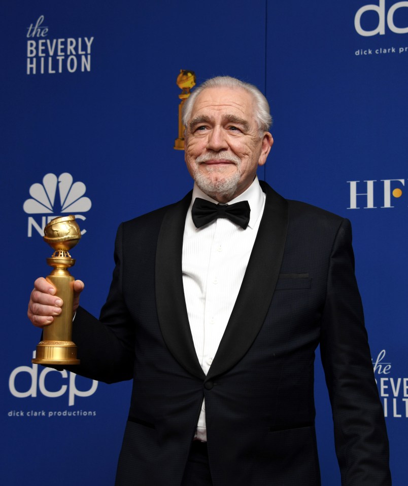  Brian beams as he holds up the Golden Globe