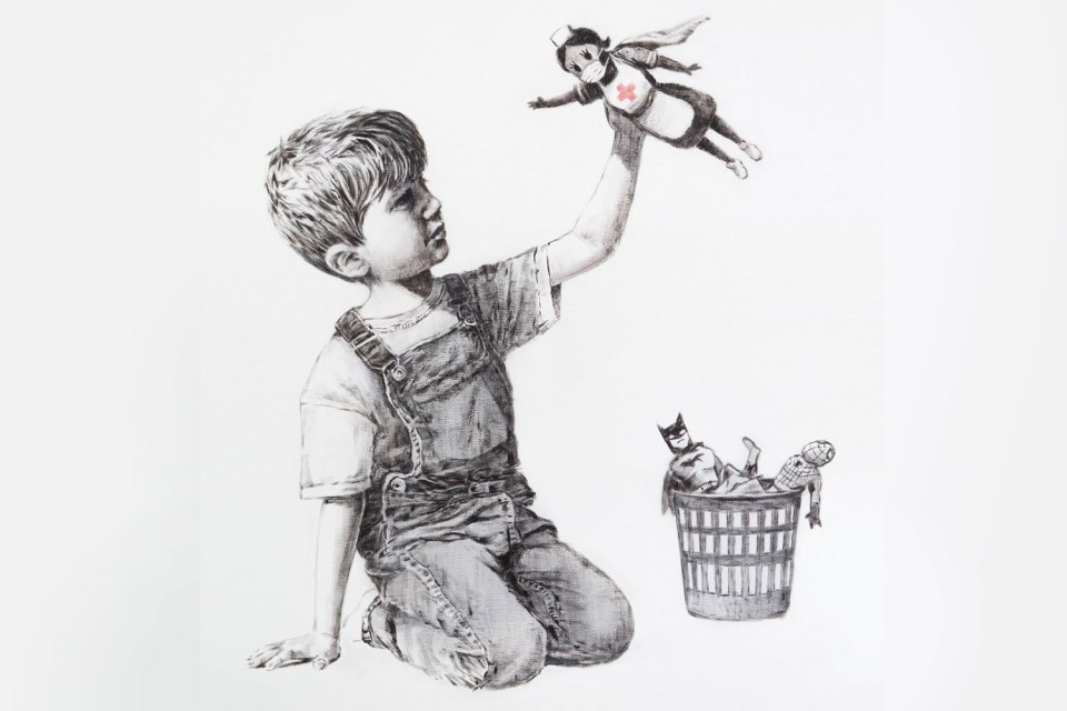 This Banksy artwork is called Game Changer and shows a boy dressed in dungarees playing with a toy nurse depicted as a superhero,