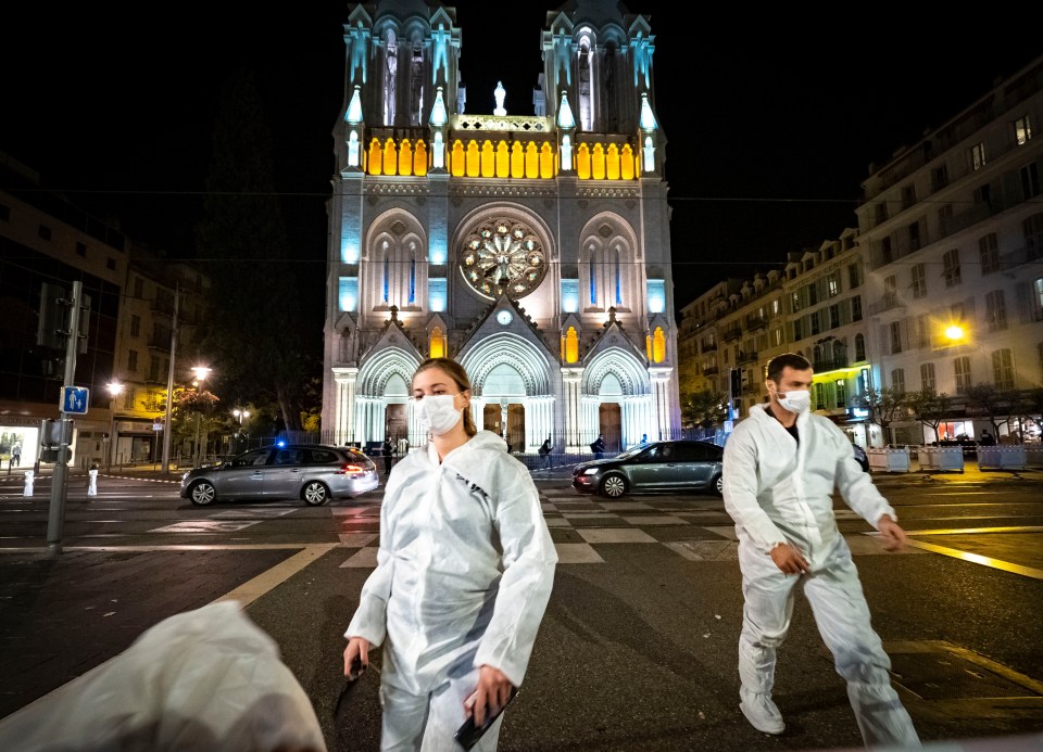 Forensic officers work in front of Notre Dame Basilica where the attacker killed three people