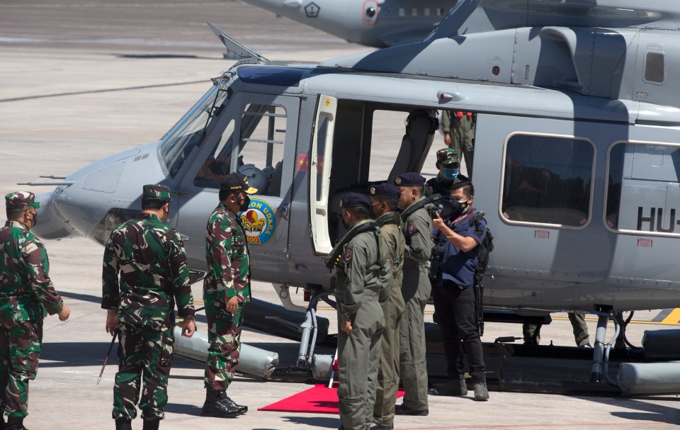 Indonesian Military chief Hadi Tjahjanto boards a helicopter during the search mission for the missing Indonesian Navy submarine KRI Nanggala
