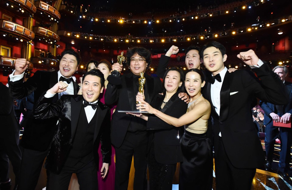 The "Parasite" cast celebrates their Best Picture Oscar win.