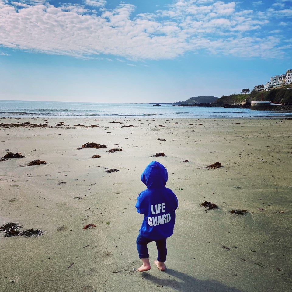 Georgette's son Jude watches waves
