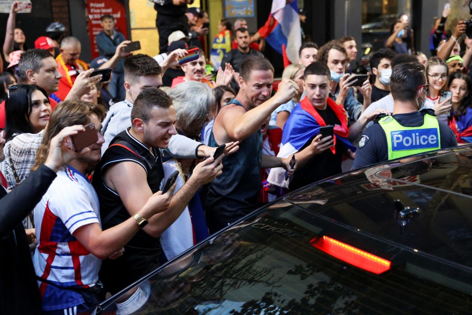 Supporters were seen chanting at a car leaving his lawyer's office as police fought to move them on