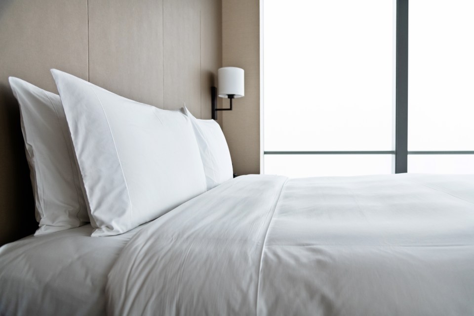 Made bed in a modern hotel room.