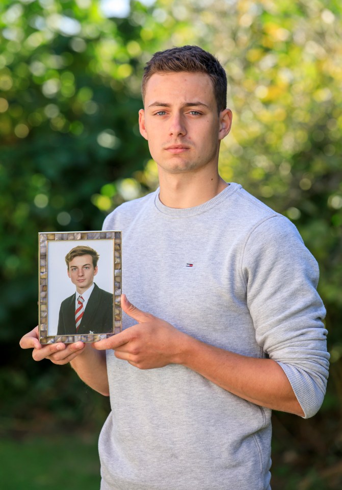 Man holding a framed photo of his deceased brother to raise awareness for mental health.