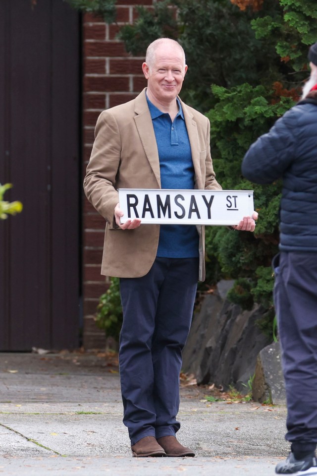 Geoff Payne was seen holding the iconic Ramsay St sign