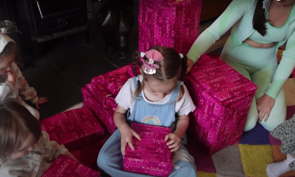 She was surrounded by presents wrapped in pink paper as the vlog began
