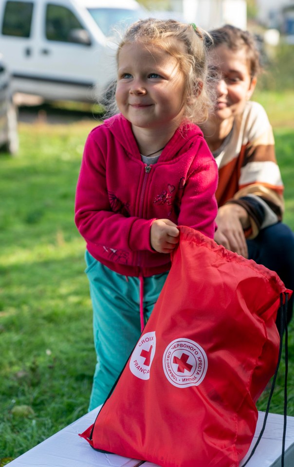 Svitlana Bachura and her three-year-old daughter queued for hours to collect their parcel