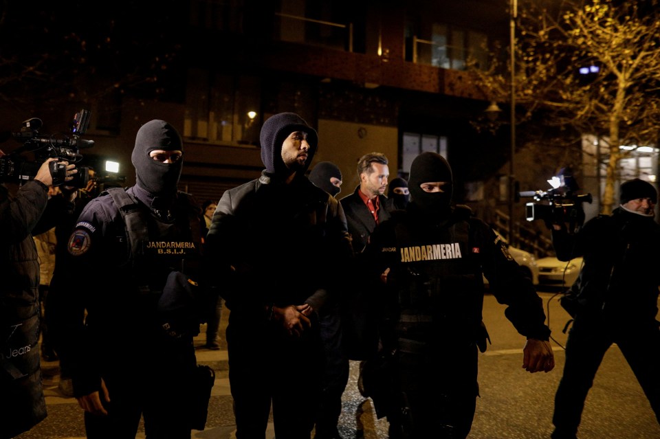 He and his brother were pictured being led away from his home in handcuffs