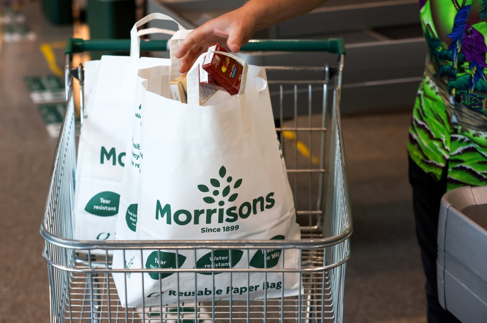 A customer places goods in to a paper bag at a Morrisons supermarket, operated by Wm Morrison Supermarkets Plc, in Saint Ives, U.K., on Monday, July 5, 2021. Apollo Global Management Inc. said Monday it's considering an offer for Morrison, heating up a takeover battle for the U.K. grocer. Photographer: Chris Ratcliffe/Bloomberg via Getty Images