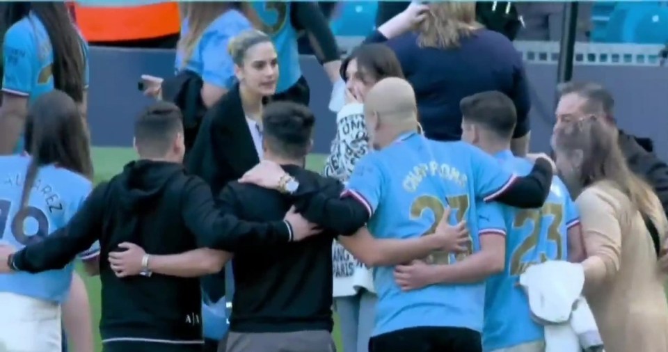 a group of people are huddled together with one wearing a number 23 jersey