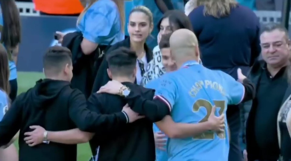 a man in a number 27 jersey is hugging another man