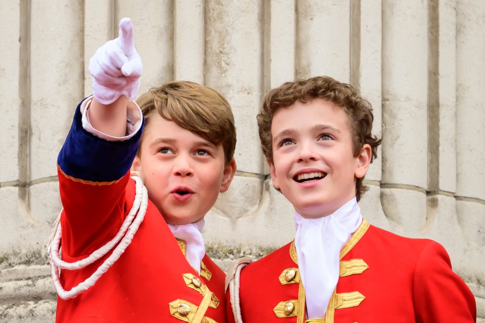 Excited Prince George points while out on the Palace balcony