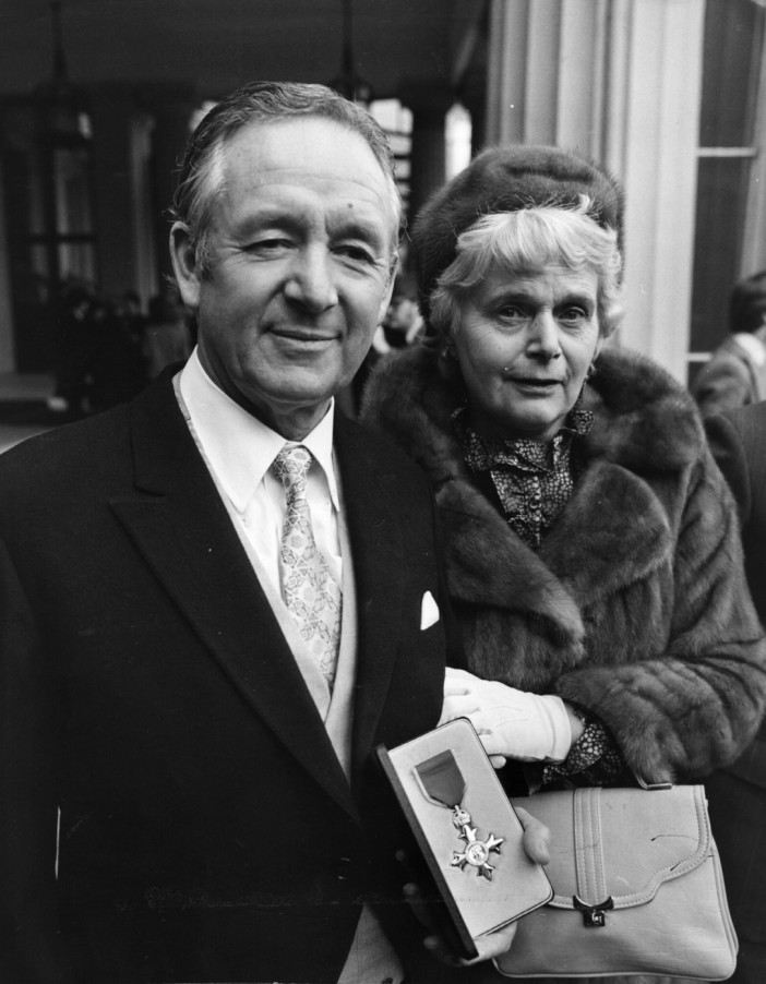 British writer James Herriot with his wife at Buckingham Palace after receiving his OBE. (Photo by Evening Standard/Getty Images)