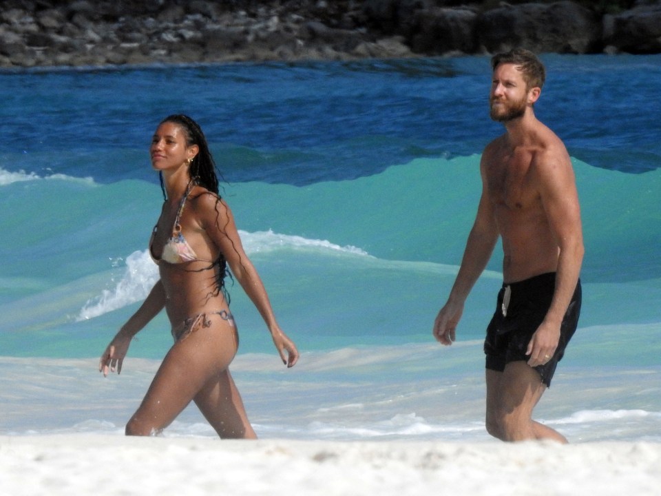 Calvin Harris and Vick Hope on a beach.