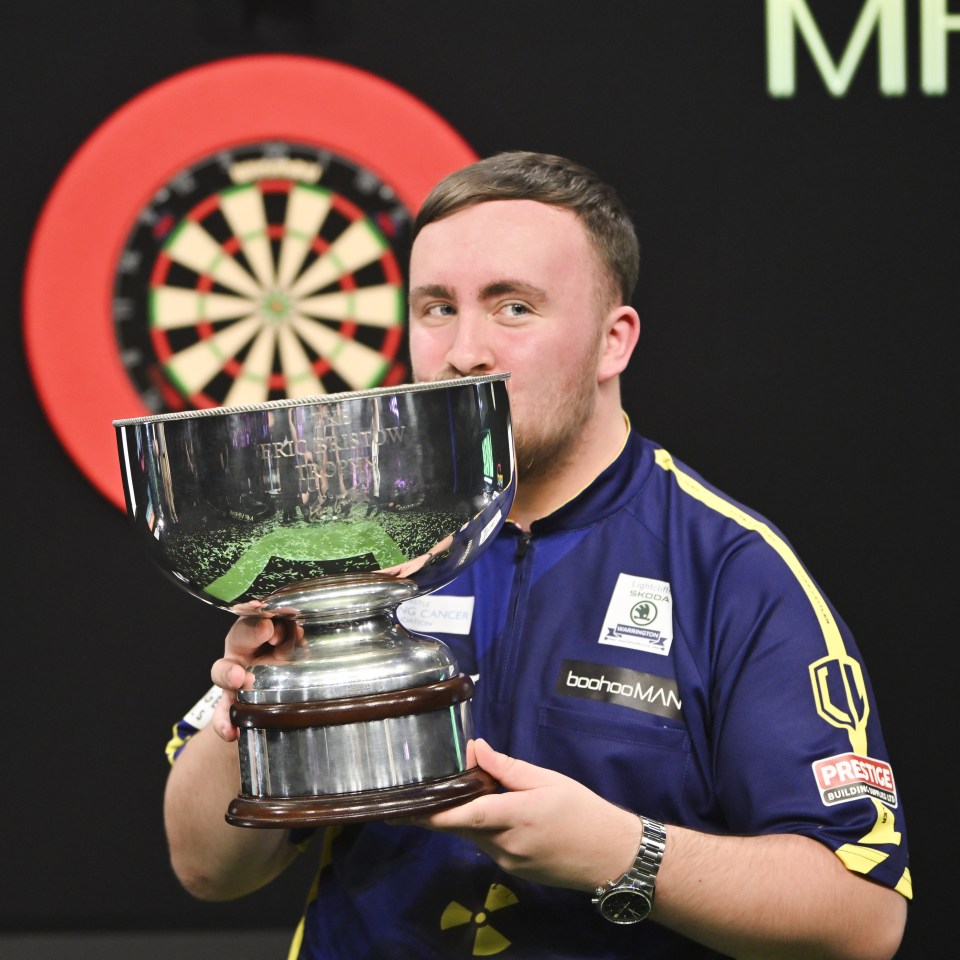 LONDON, ENGLAND - JANUARY 03: Runner-up Luke Littler of England celebrates with the runner-up trophy after the 2023/24 Paddy Power World Darts Championship Final between Luke Littler of England and Luke Humphries of England on Day Sixteen of the 2023/24 Paddy Power World Darts Championship at Alexandra Palace on January 03, 2024 in London, England. (Photo by Tom Dulat/Getty Images)