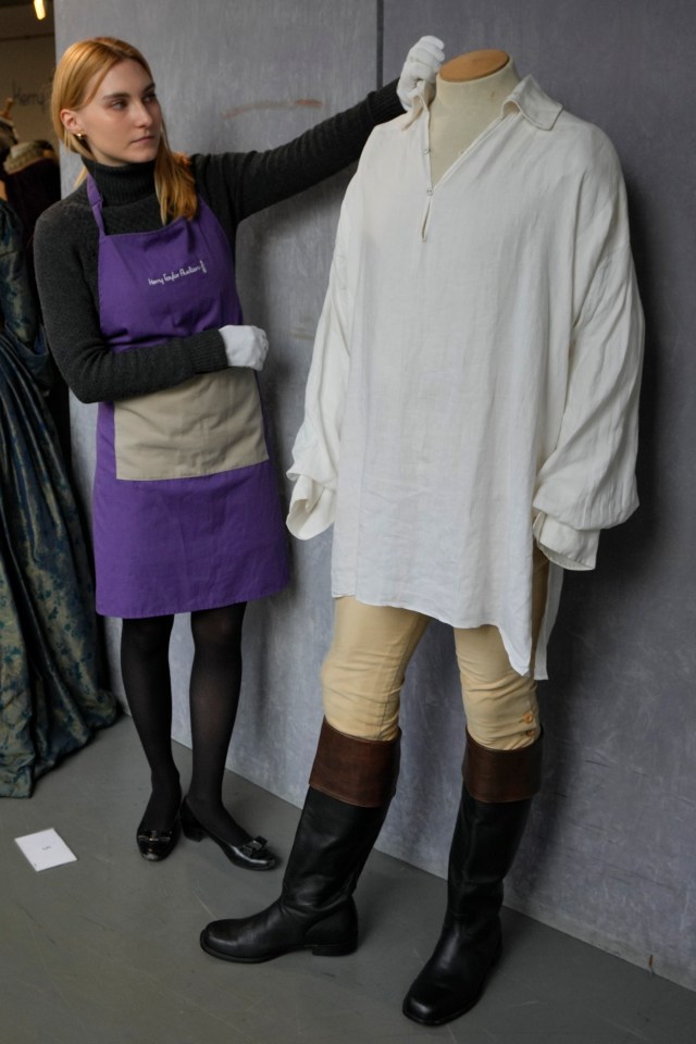 A costume handler arranges Colin Firth’s ‘wet-shirt’ costume as Mr Darcy in the TV series Pride and Prejudice at Kerry Taylor Auctions in London