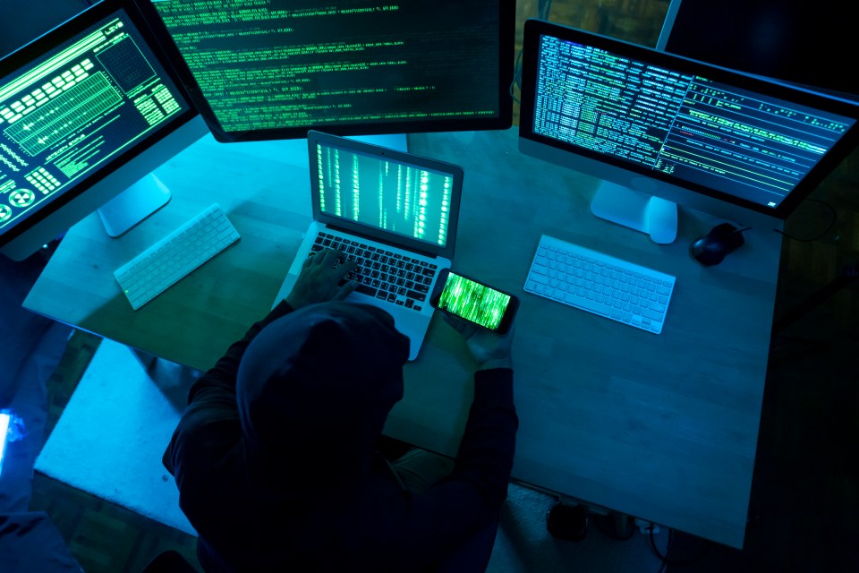 Male Hacker Working On The Laptop And Computer