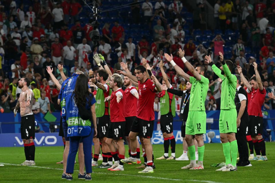 Georgia's players celebrate after winning the UEFA Euro 2024 Group F football match between Georgia and Portugal at the Arena AufSchalke in Gelsenkirchen on June 26, 2024. (Photo by OZAN KOSE / AFP) (Photo by OZAN KOSE/AFP via Getty Images)