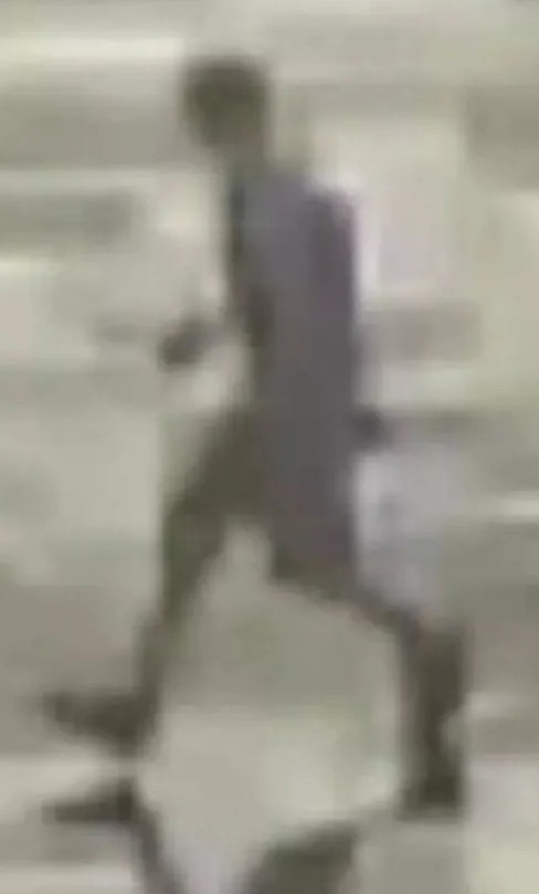 a blurry picture of a person walking on a sidewalk .