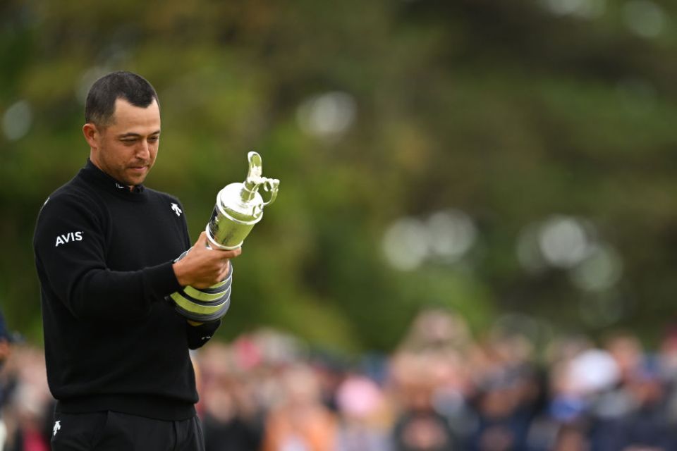 TROON, SCOTLAND - JULY 21: Xander Schauffele of the United States holds the Claret Jug on the 18th green in celebration of victory on day four of The 152nd Open championship at Royal Troon on July 21, 2024 in Troon, Scotland. (Photo by Luke Walker/R&A/R&A via Getty Images)