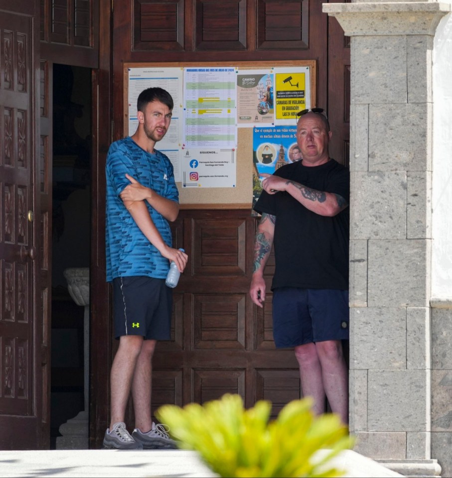 two men standing in front of a building with a sign that says rios temple