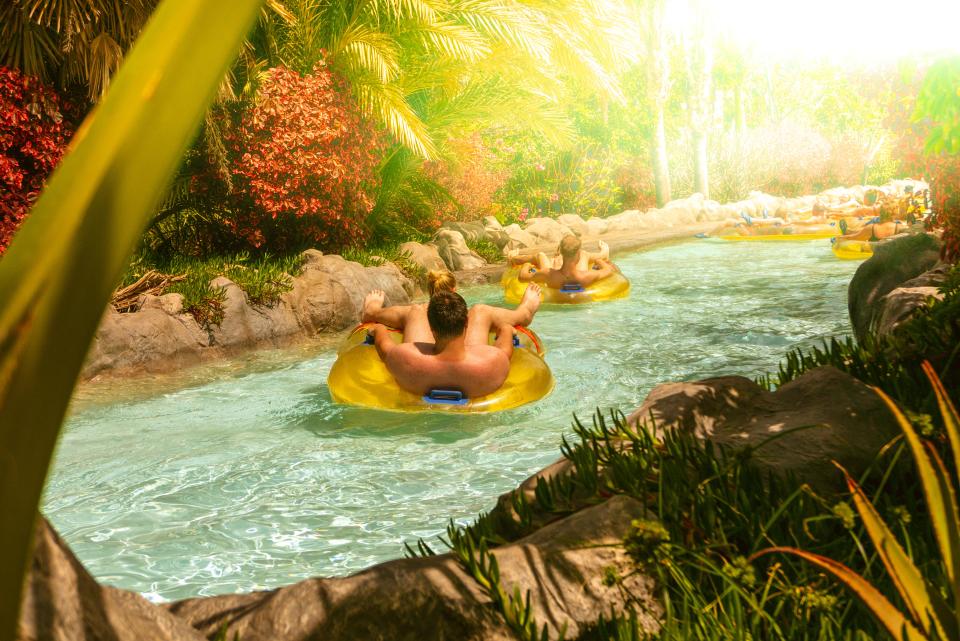 a man and a woman are floating down a river on tubes