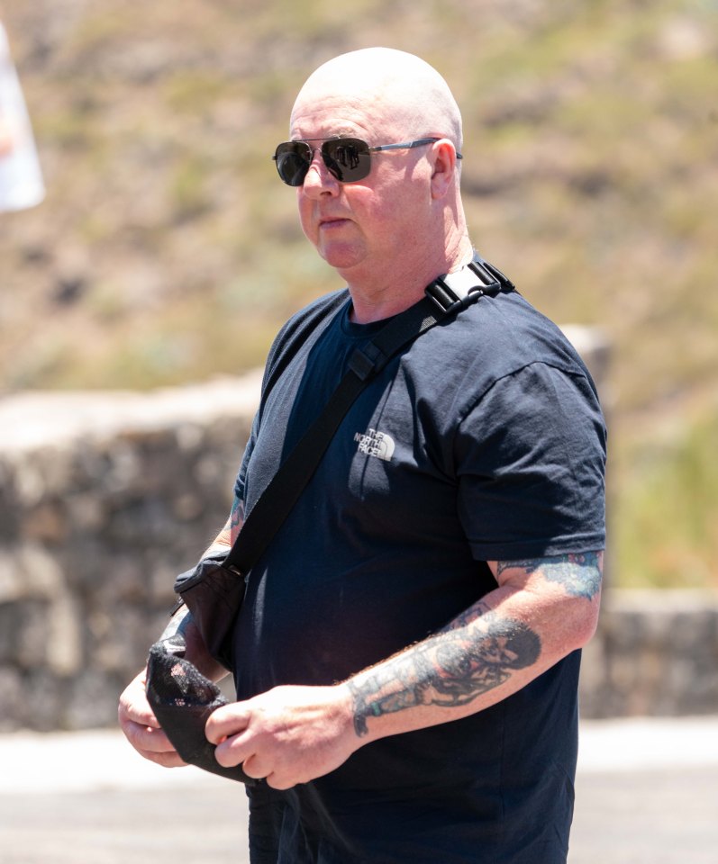 a bald man wearing sunglasses and a black north face shirt