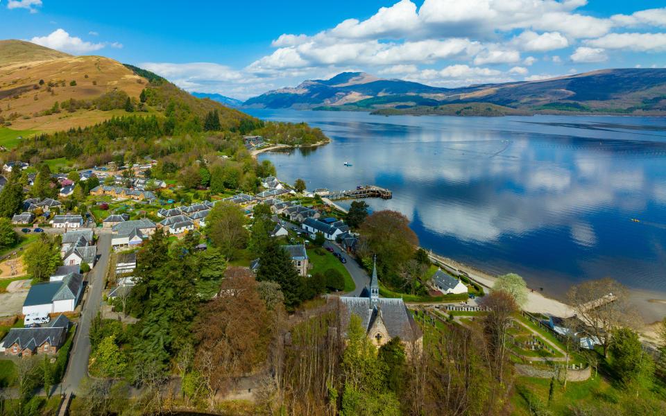 an aerial view of a small town on the shore of a lake