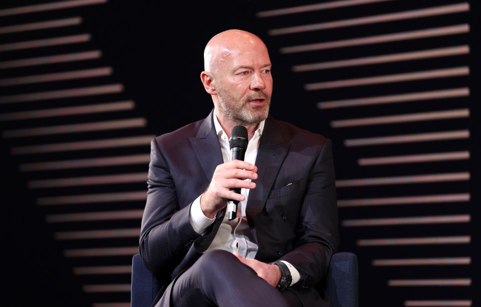 a man in a suit is holding a sennheiser microphone