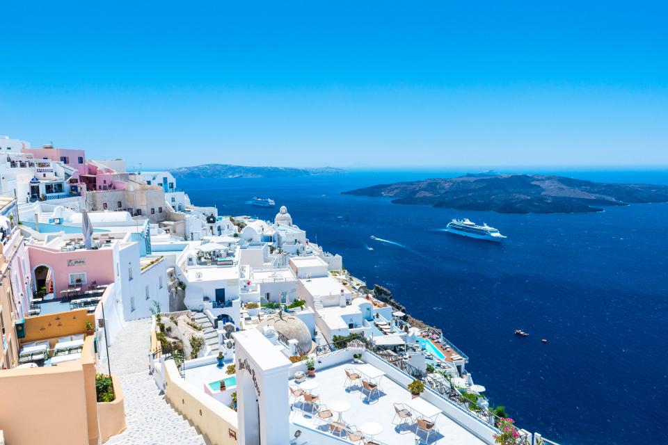 a cruise ship is in the ocean near a small island