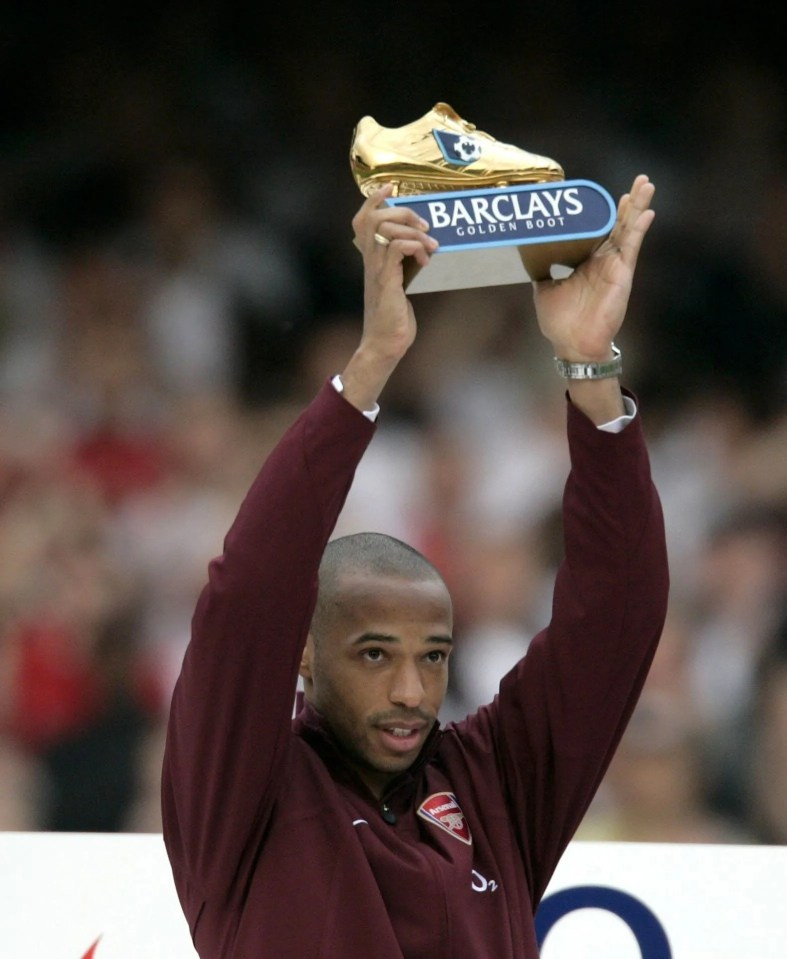 a man holds up a barclays golden boot