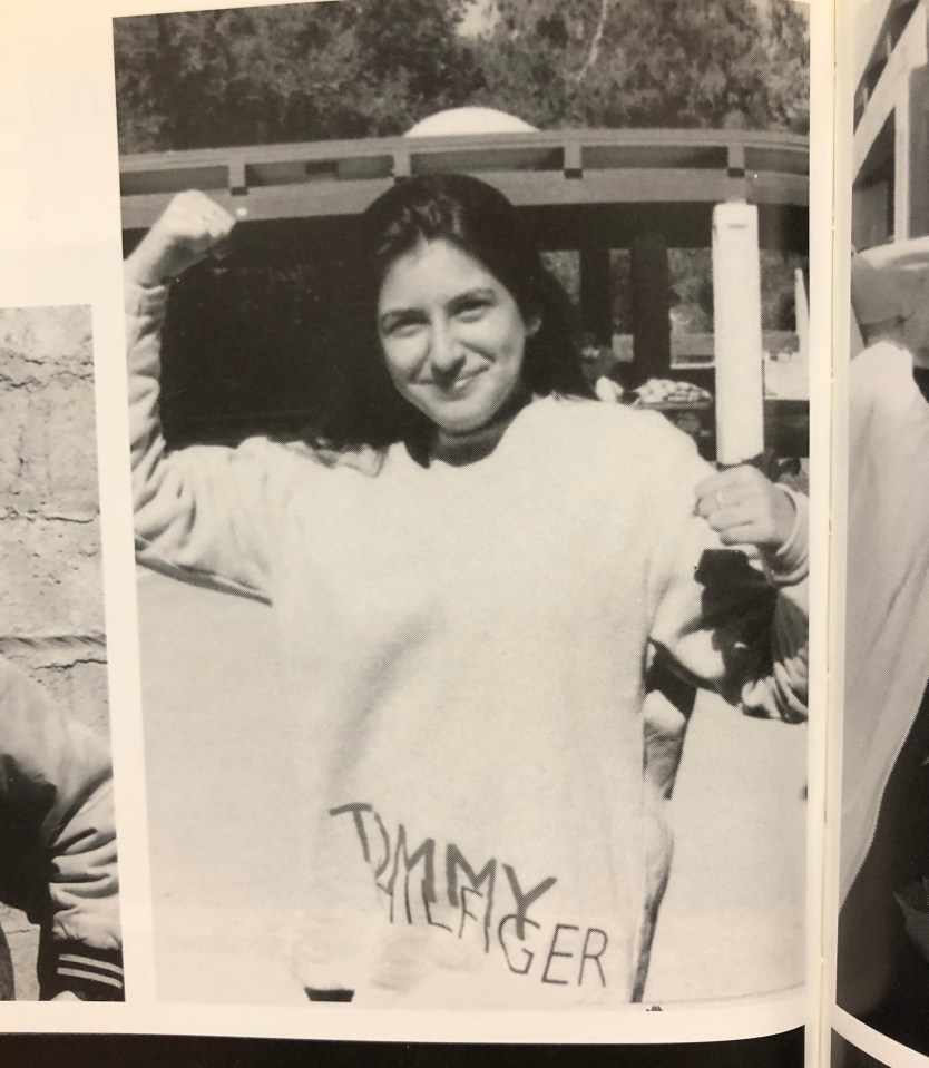 a black and white photo of a woman wearing a tommy hilfiger sweater