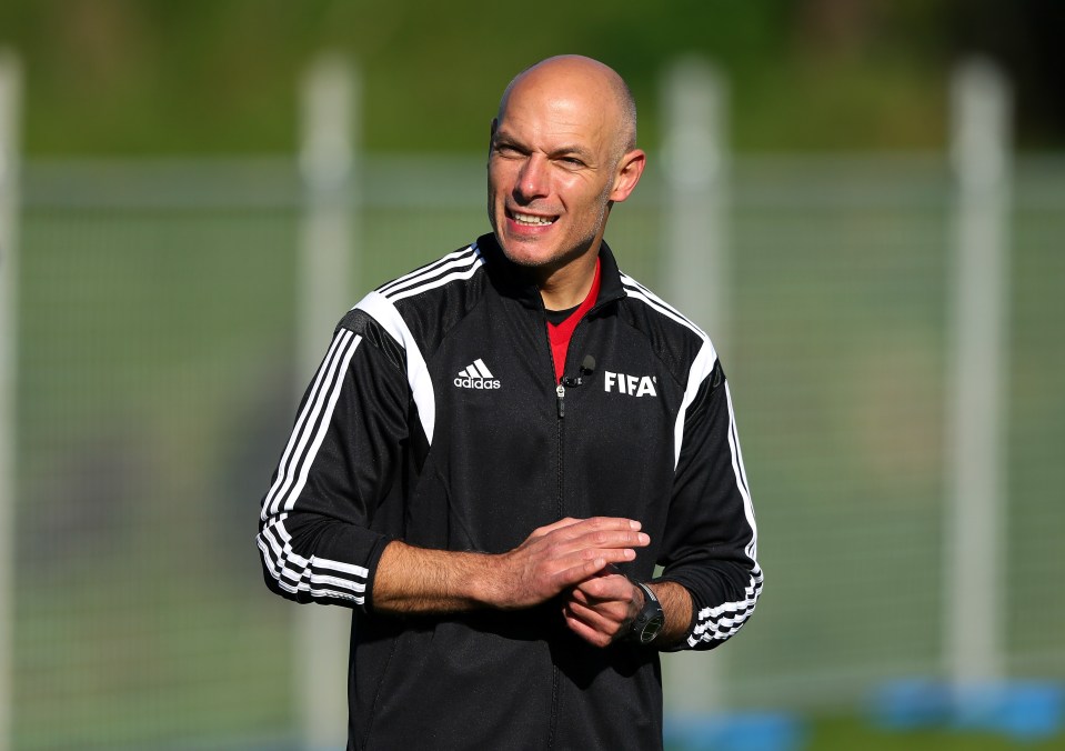 a man wearing a black adidas jacket is smiling