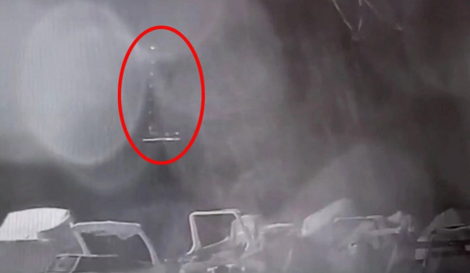 a black and white photo with a red circle in the middle