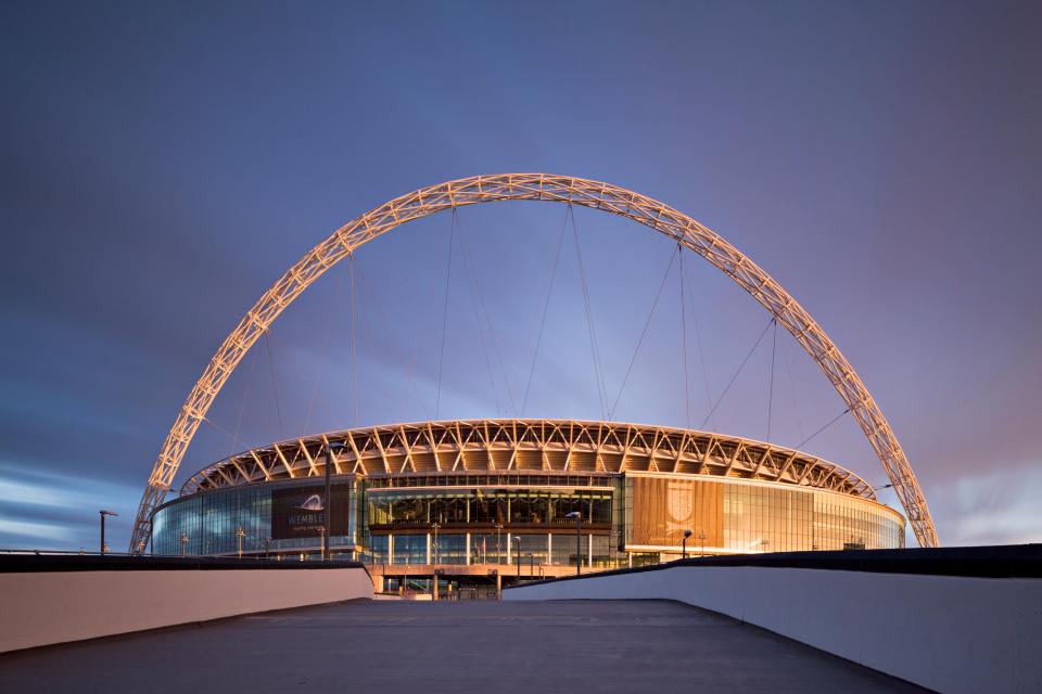 a large stadium with a large arch in the middle