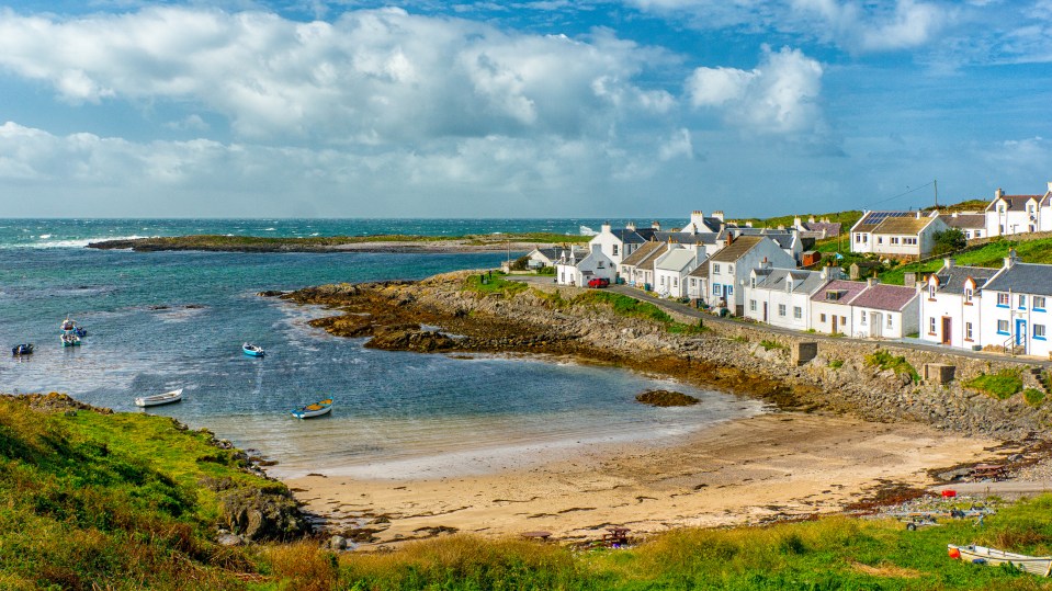 a small fishing village with boats in the water
