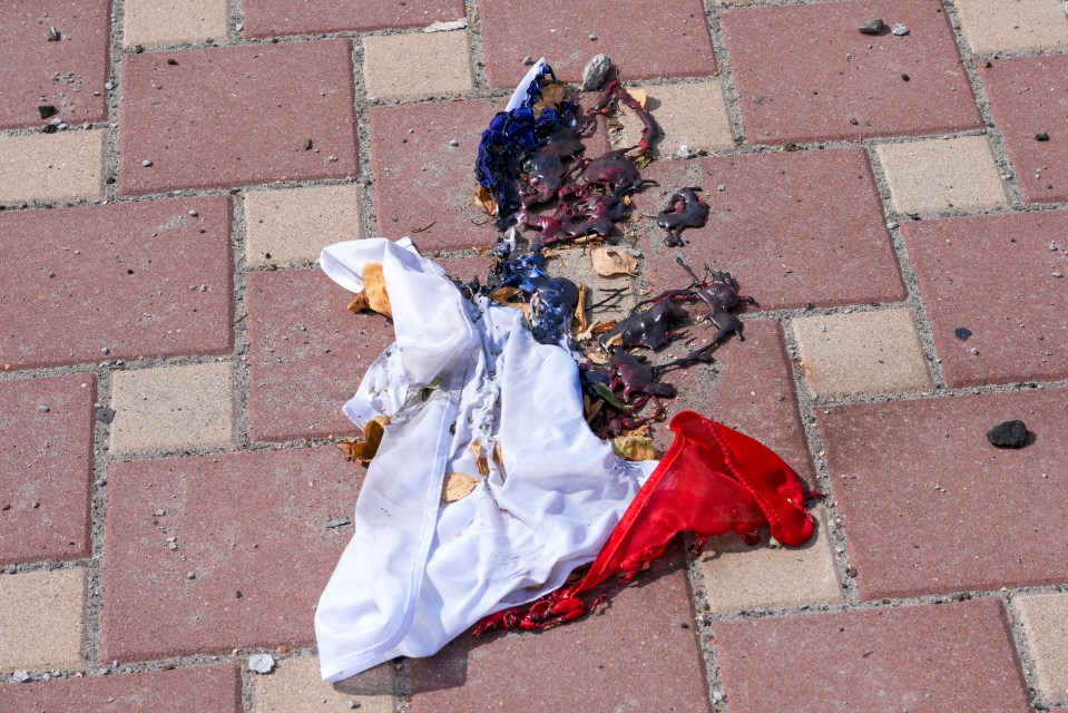 A burnt and melted Russian flag in the main square of Sudzh