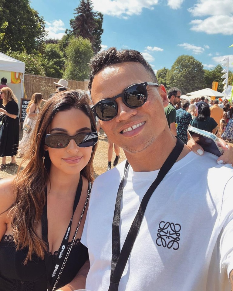 a man wearing a loewe shirt poses with a woman