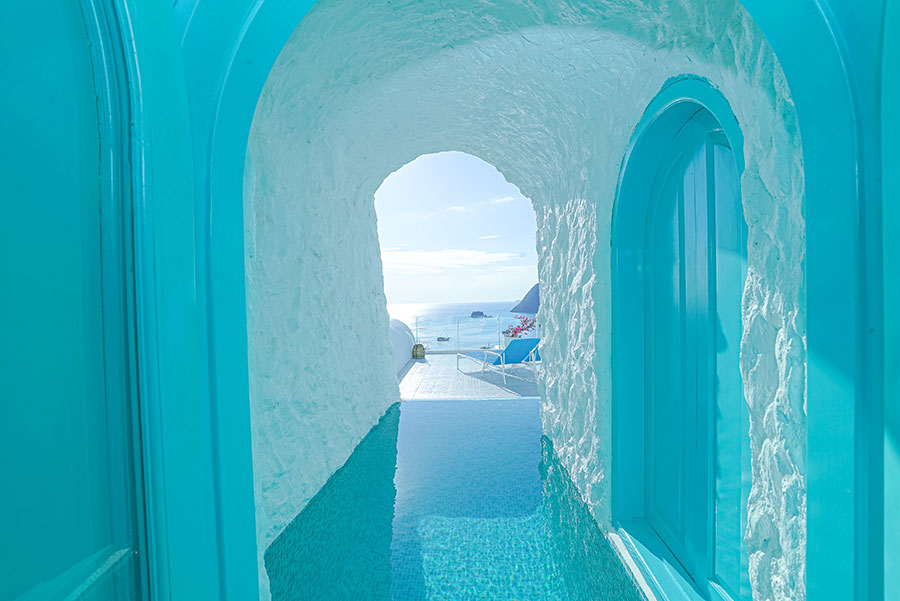 a blue archway leads to a swimming pool