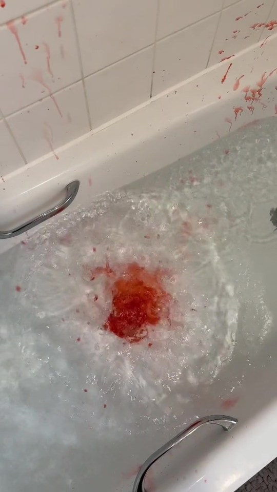 a bathtub filled with water and red liquid